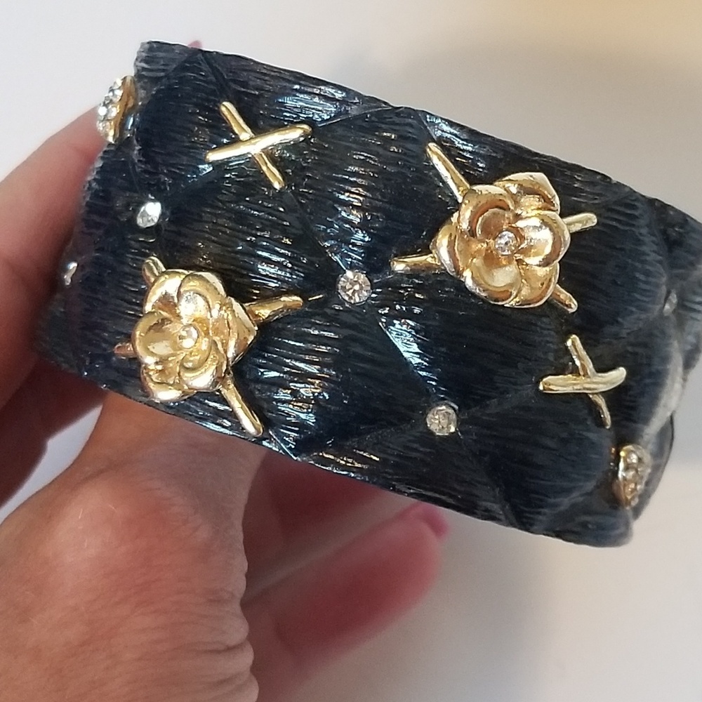 Black resin cuff bracelet with gold tone accents